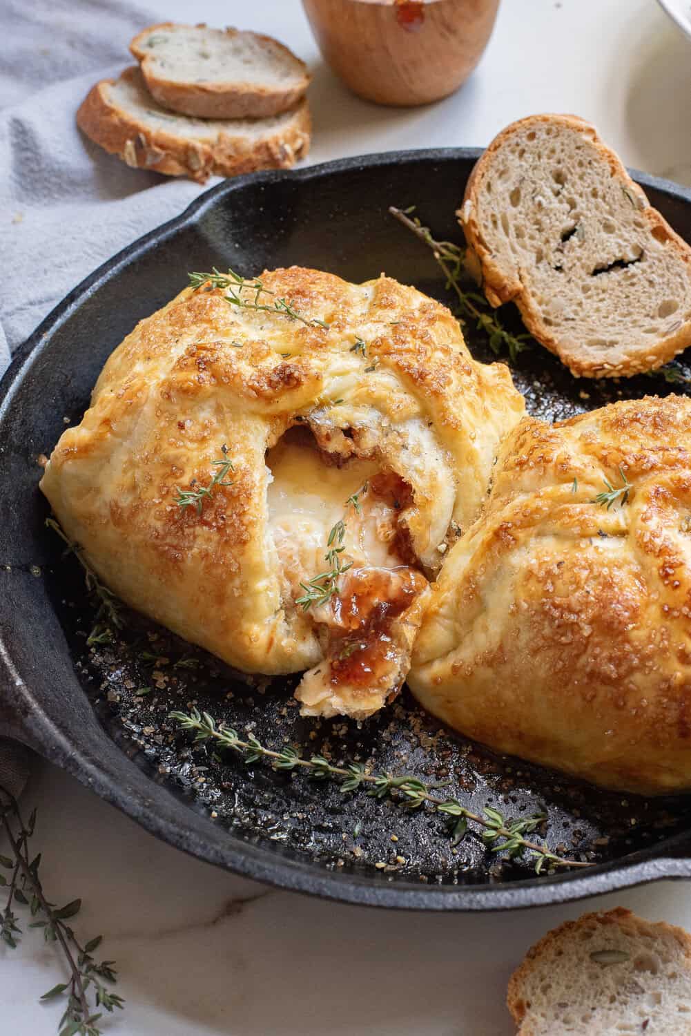 baked brie in a skillet with brie oozing out