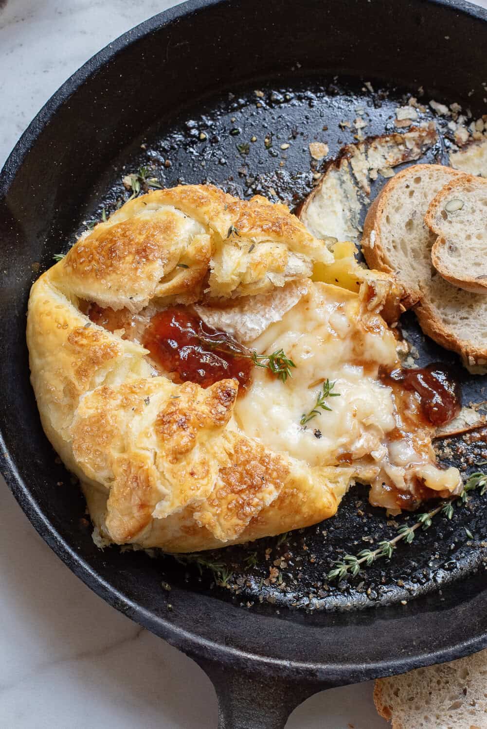 Baked Brie in Puff Pastry with Fig Jam in a skillet