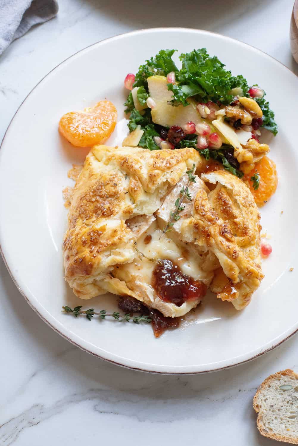 Baked Brie in Puff Pastry on a plate with a salad