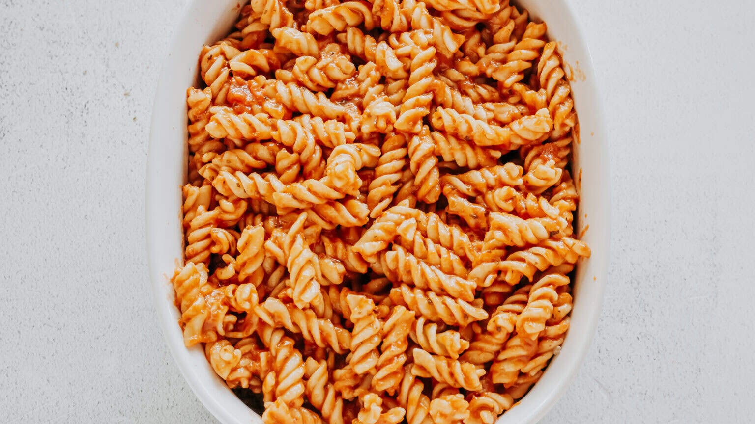 pasta with pizza sauce over ground beef and cream cheese