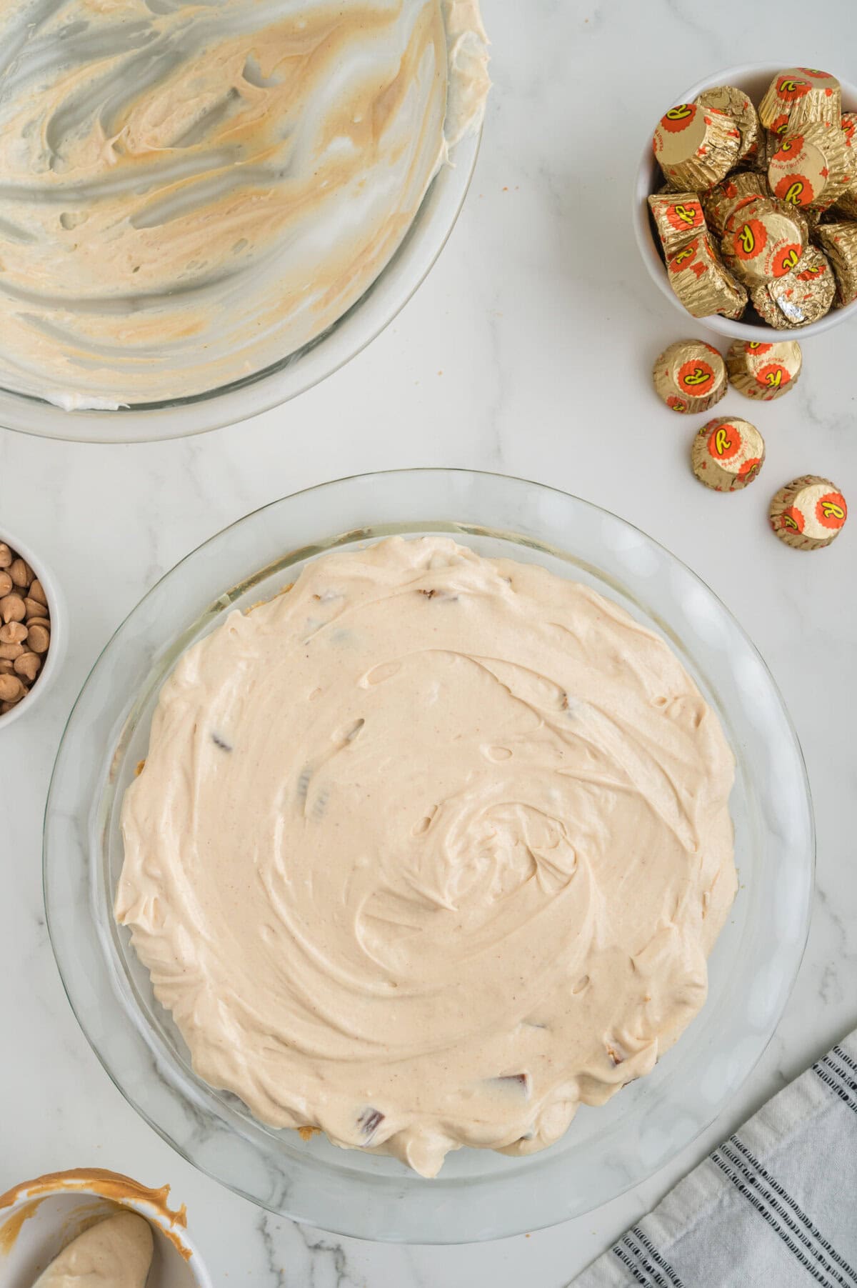 chopped reese's cups in peanut buttter pie filling mixture spread into baked pie crust