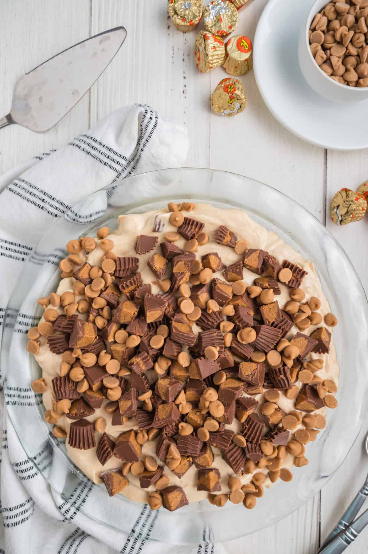 peanut butter pie topped with peanut butter chips and mini reese's cups