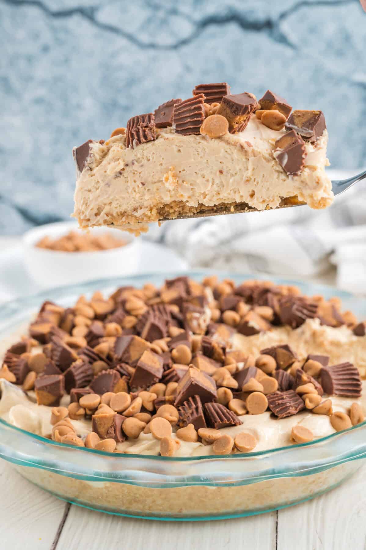 a slice of peanut butter pie being lifted out of pie plate