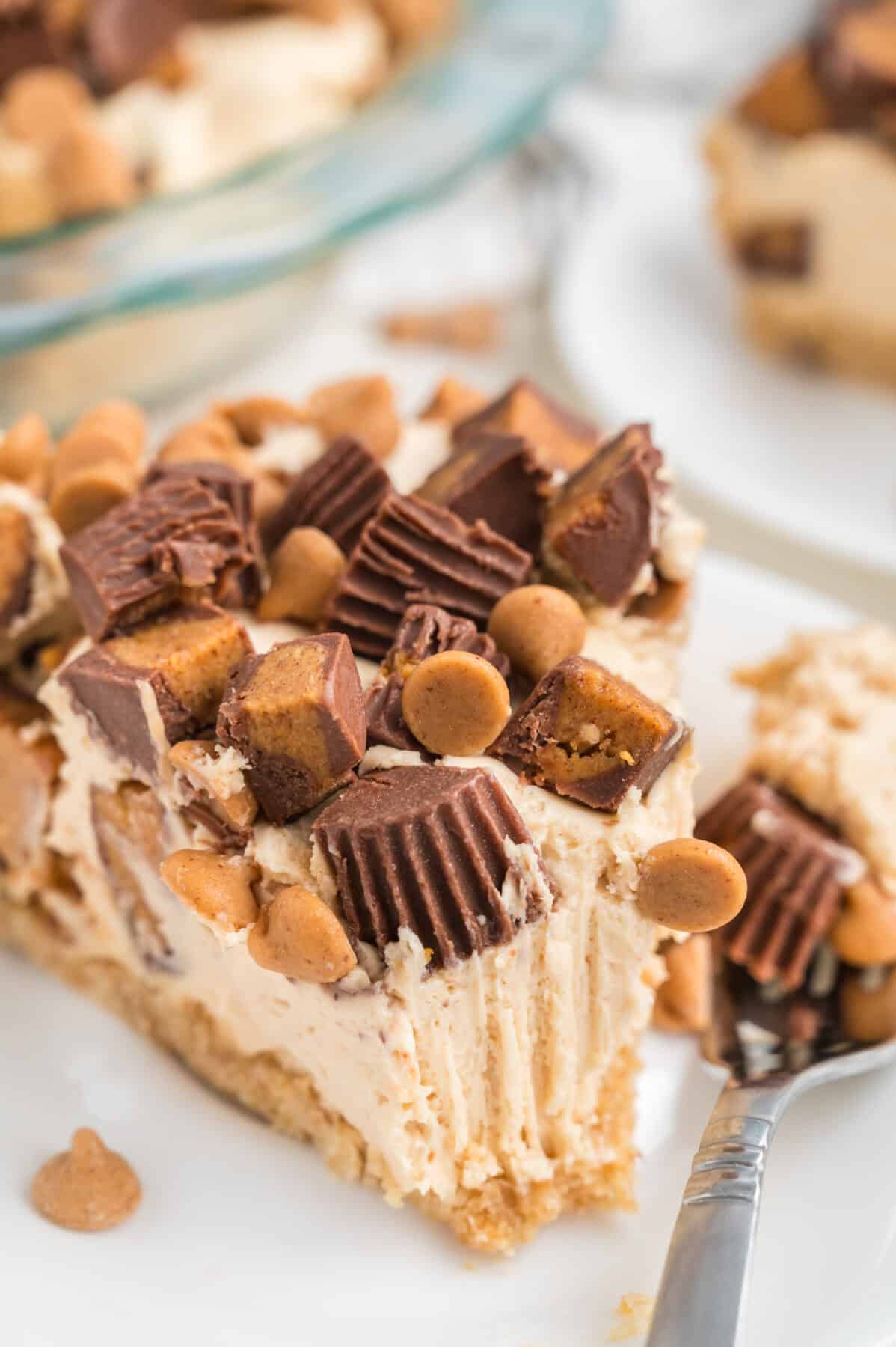 slice of peanut butter chocolate pie topped with chopped Reese's cups