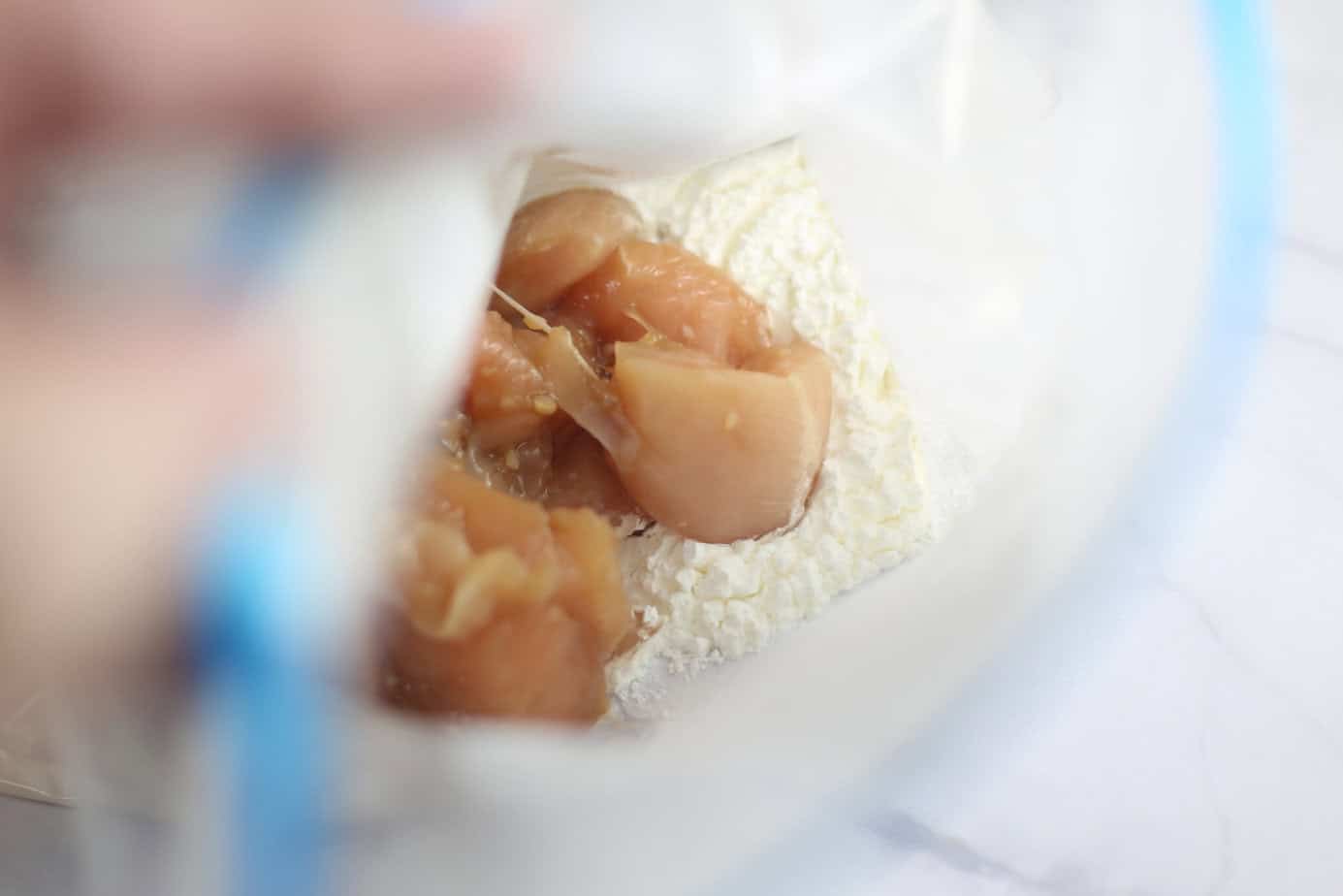 marinated chicken in ziploc bag with flour