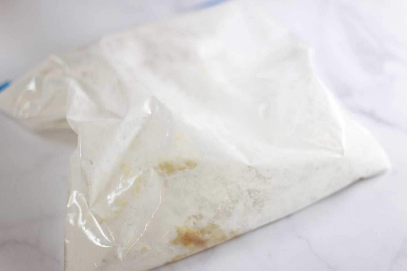 ziploc bag with chicken inside after shaking