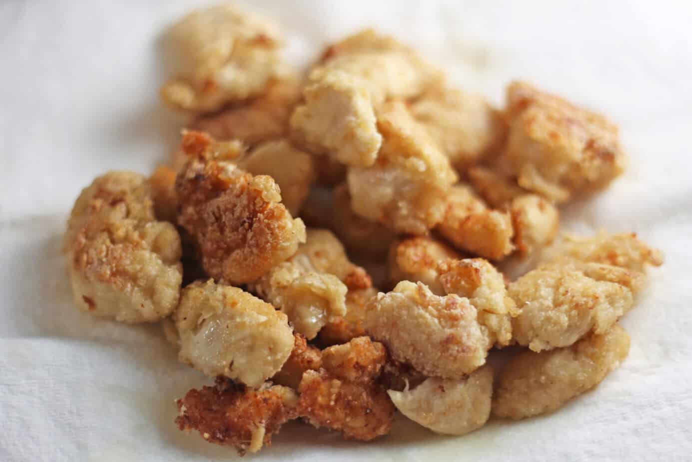 fried chunks of chicken on a paper towel for draining