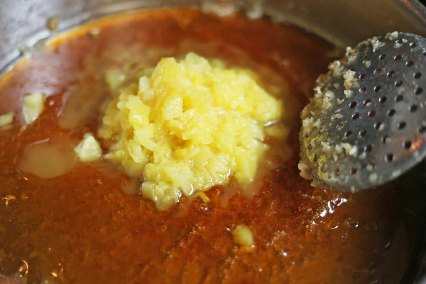 orange sauce and pineapple in skillet