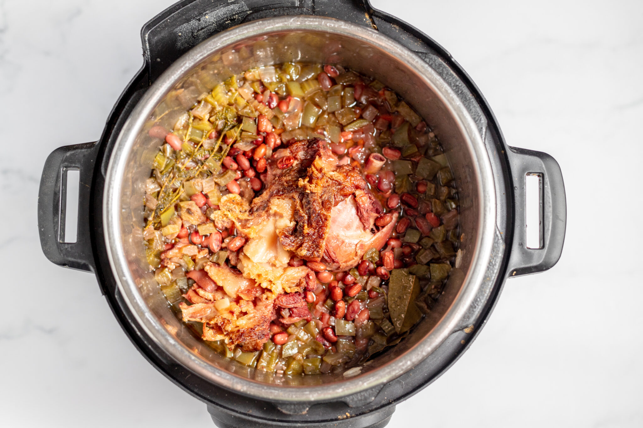 cooked instant pot red beans and rice with ham hock in pot