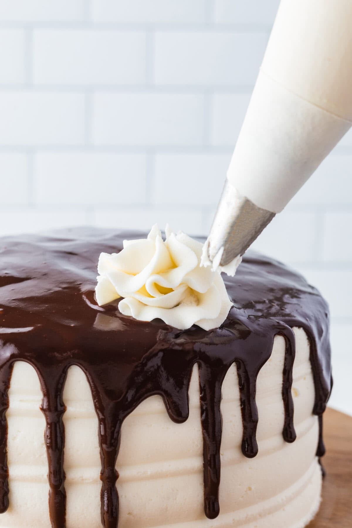 Piping Cream Cheese Frosting on a Red Velvet Cake