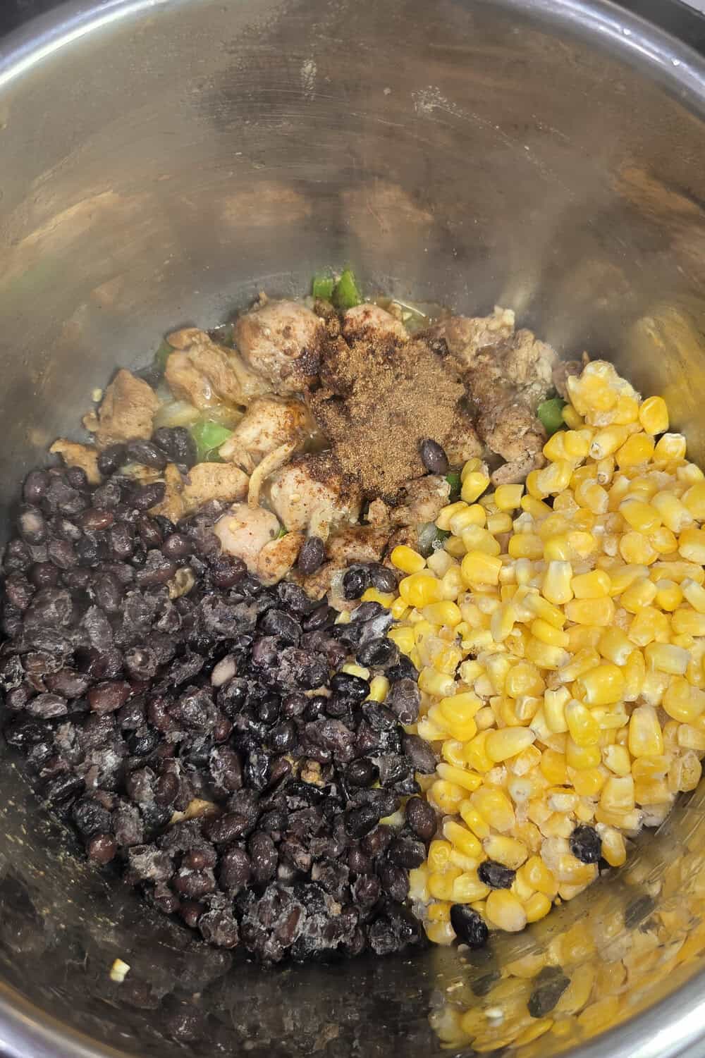 black beans and corn added to cooked chicken in instant pot