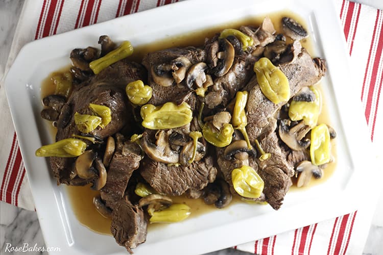 Mississippi Pot Roast topped with peperoncini and mushrooms - served on a white platter