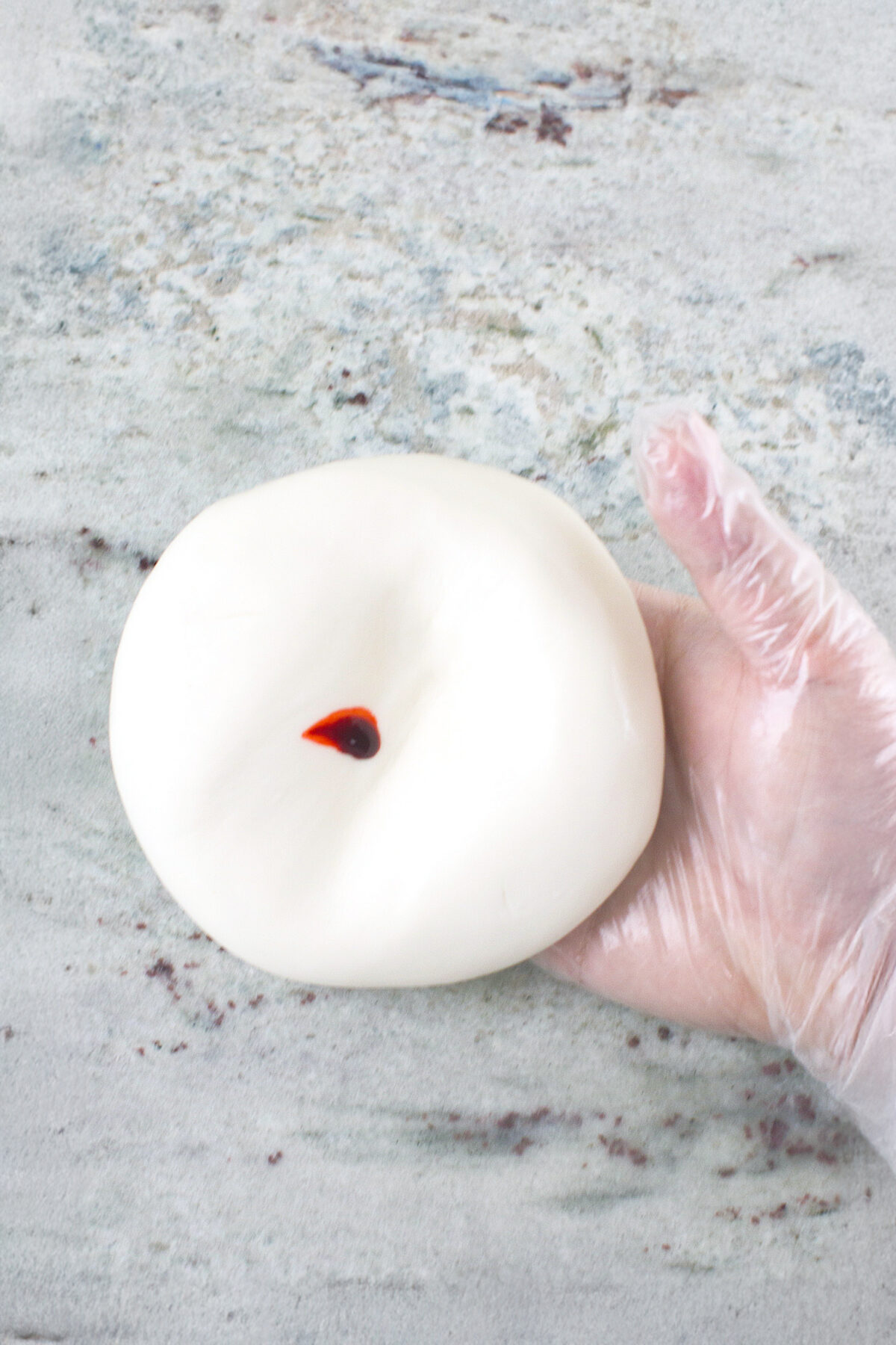 dot of pink on ball of fondant