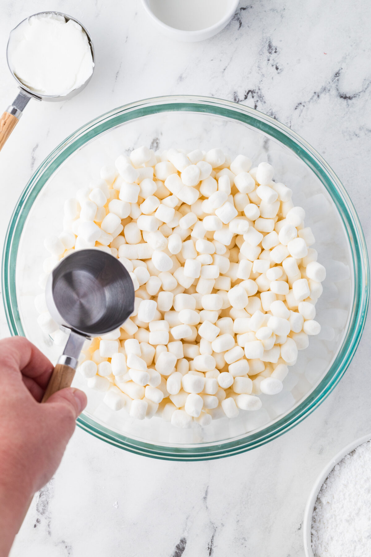 adding water to marshmallows in a bowl