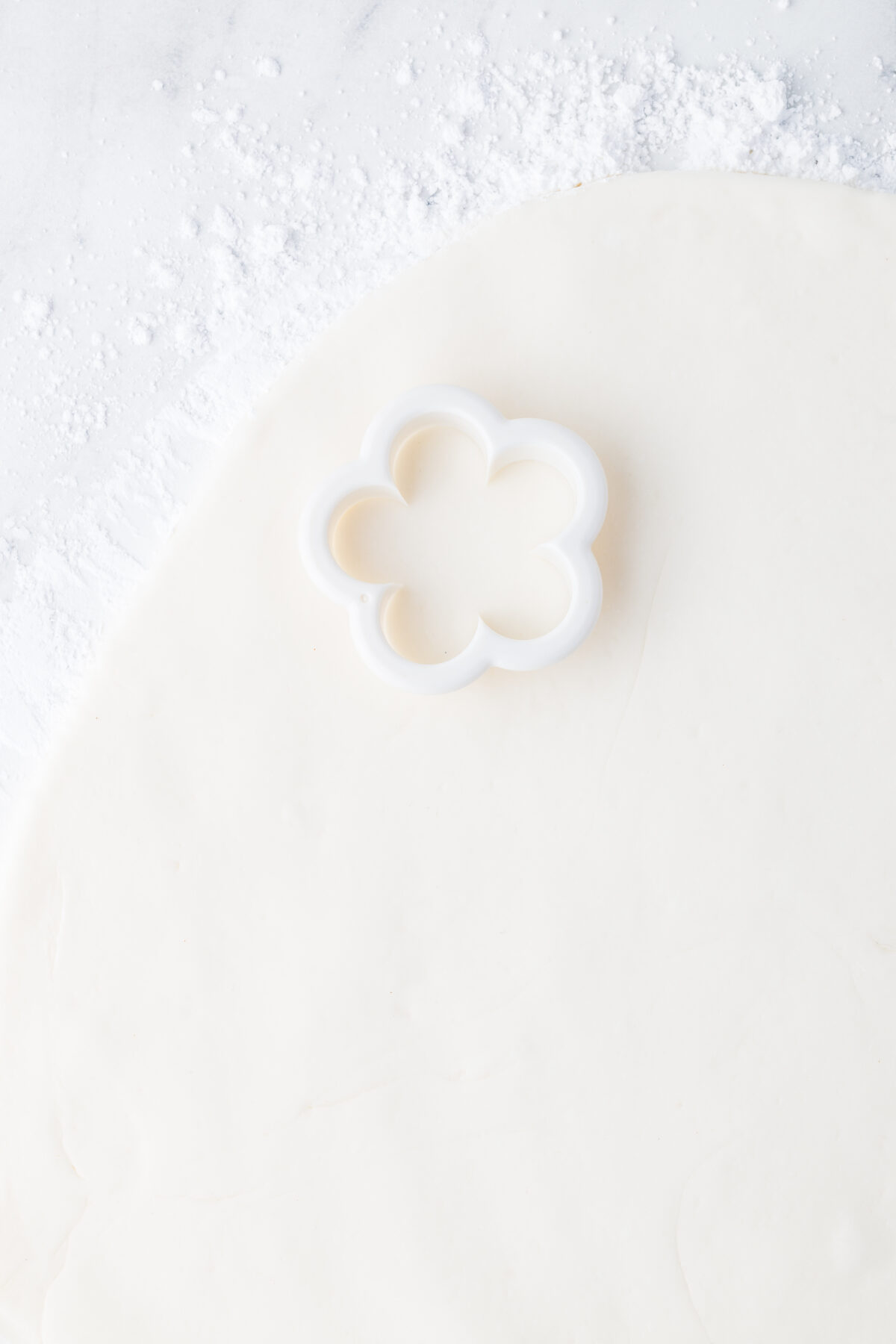rolled out fondant with a flower cutter on it