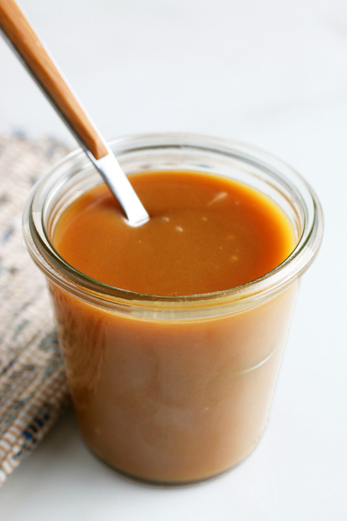 homemade caramel sauce in a glass jar