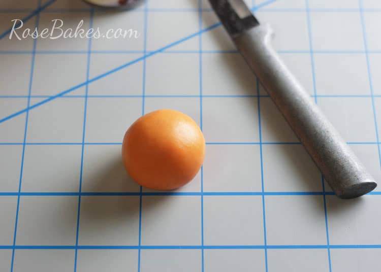 orange fondant and sculpting tool