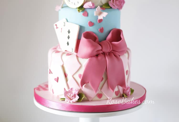 A zoom in of the 2 bottom tiers of the alice and wonderland cake