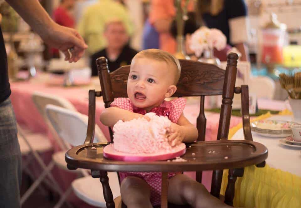 baby getting into a smash cake