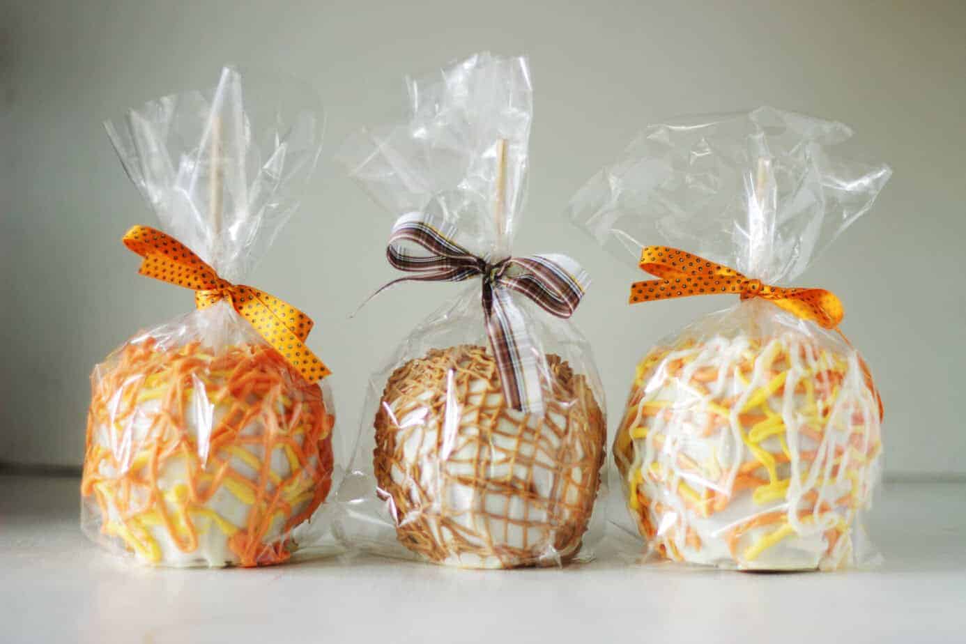 Gourmet White Chocolate Caramel Apples with wooden sticks and pretty bows.