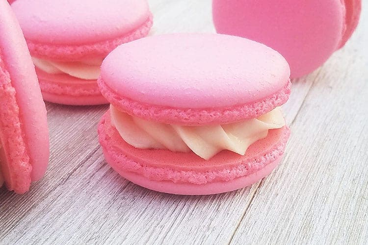 Strawberry Cheesecake Macarons on gray board