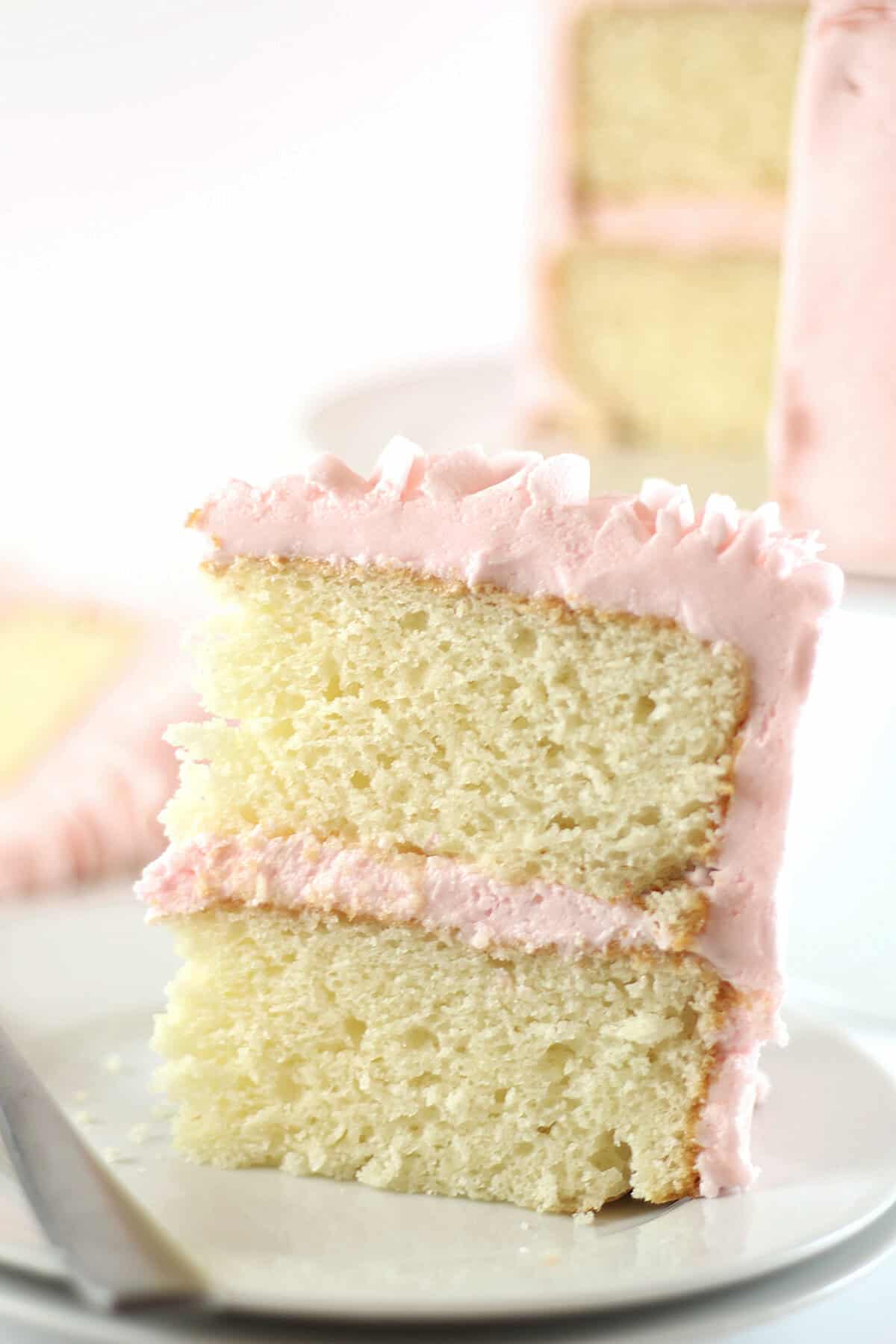 white almond sour cream cake slice on a plate