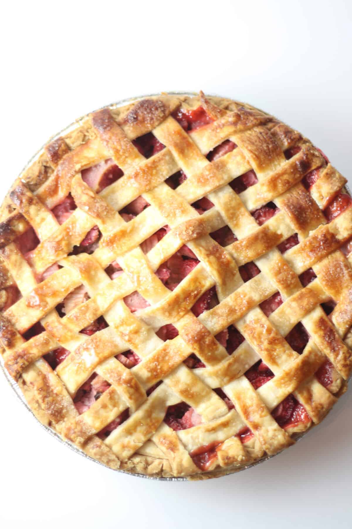 whole strawberry rhubarb pie with lattice crust