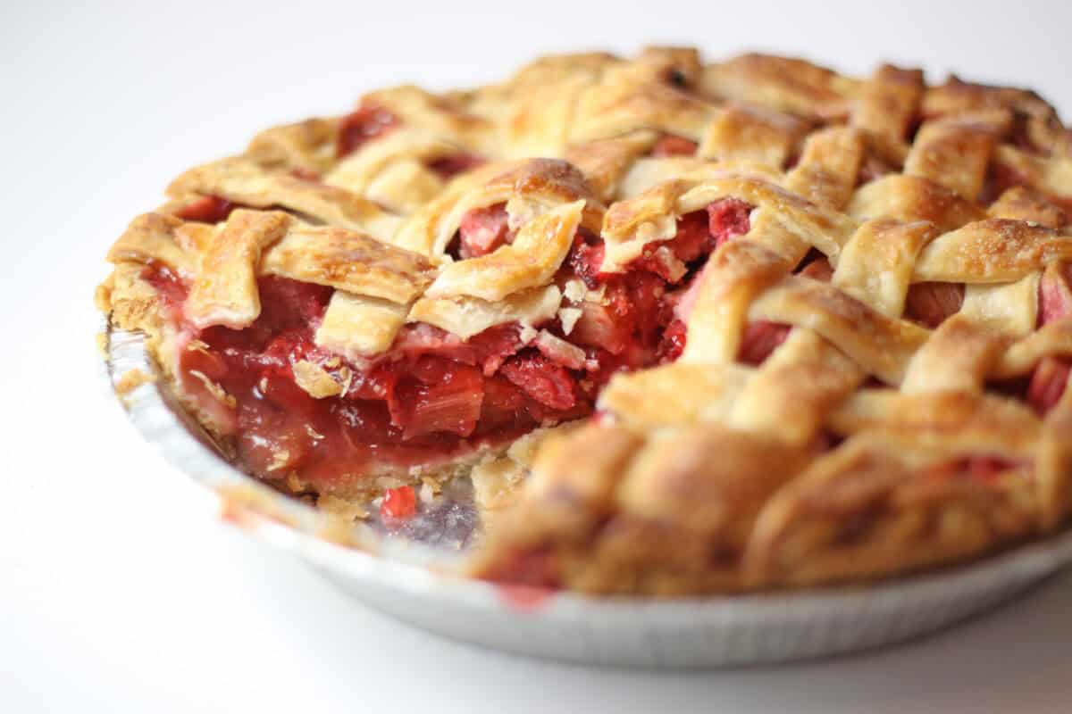 strawberry rhubarb pie with slice missing