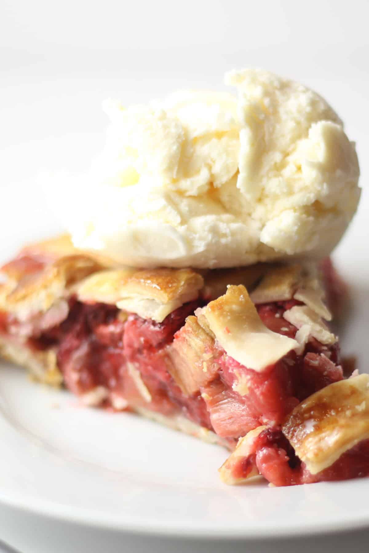 strawberry rhubarb pie with vanilla ice cream on top