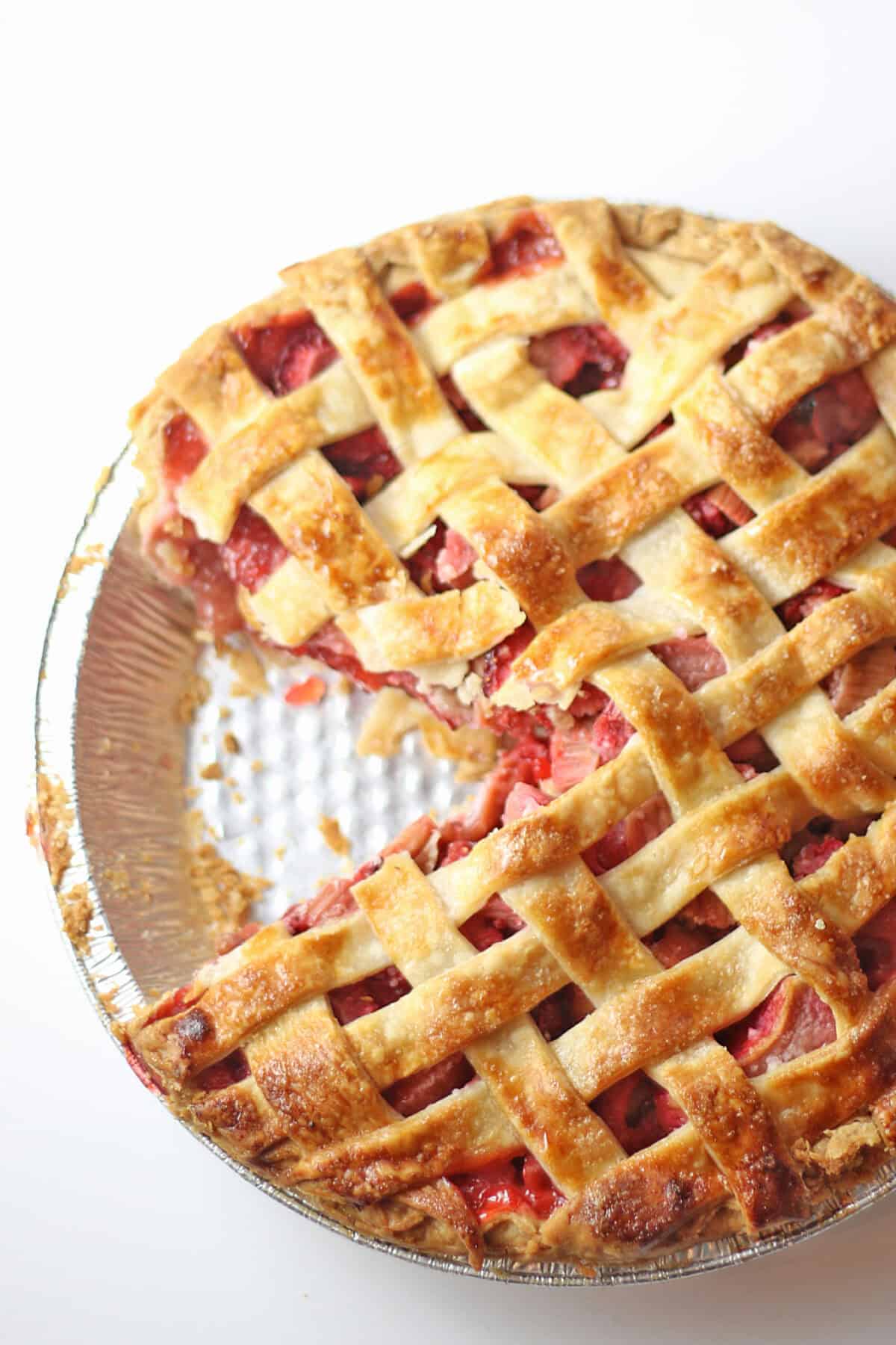 strawberry rhubarb pie with slice missing
