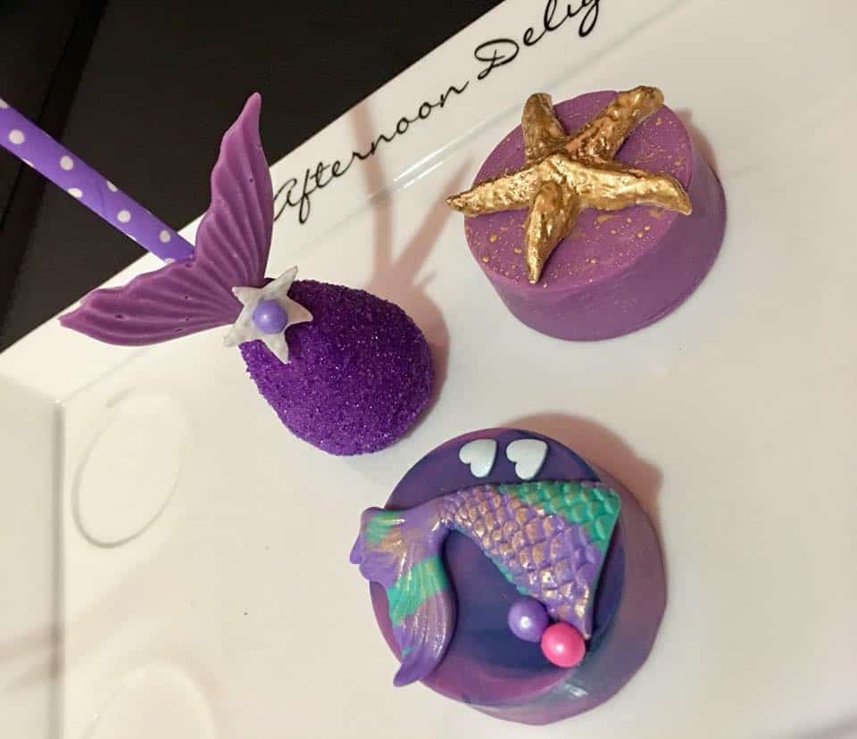 Cake Pop shaped like a purple mermaid tail and Dipped Oreos with a mermaid tail on one and a gold starfish on the other.