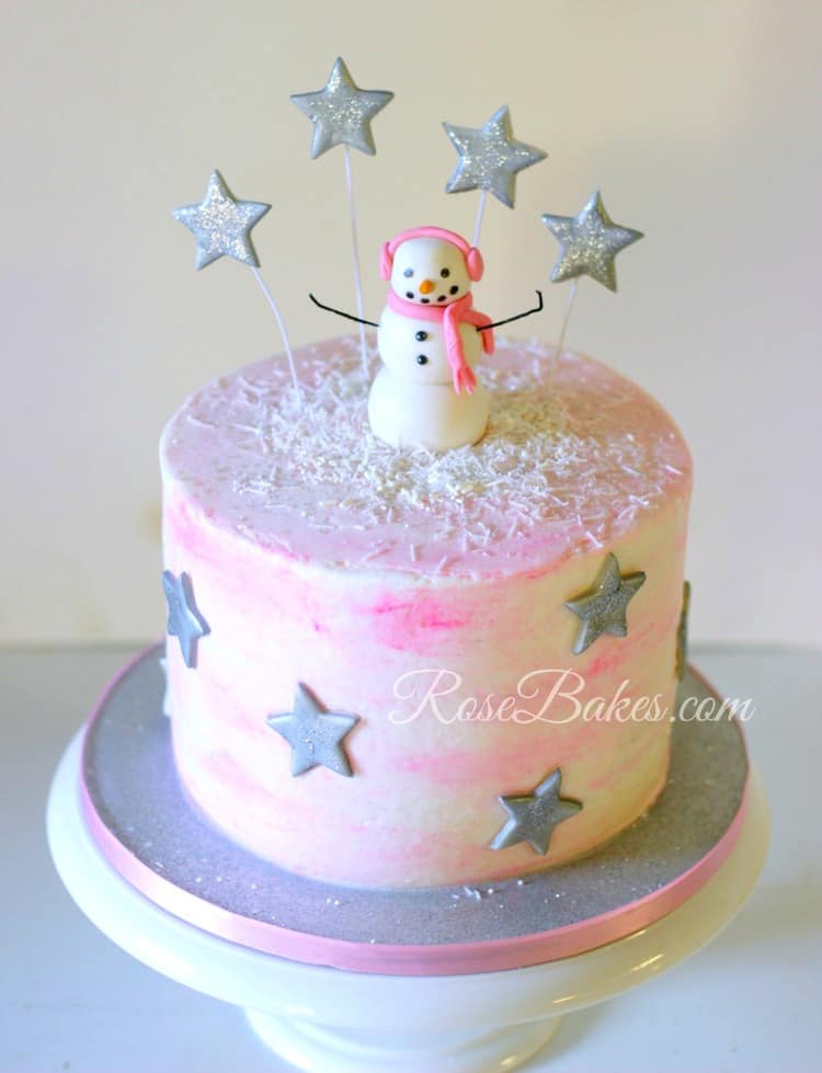Single tiered white-ish pink cake with stars on it
