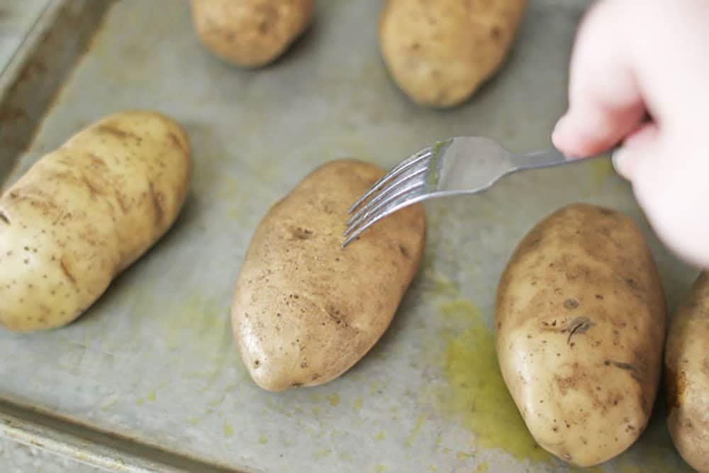poking potatoes with a fork