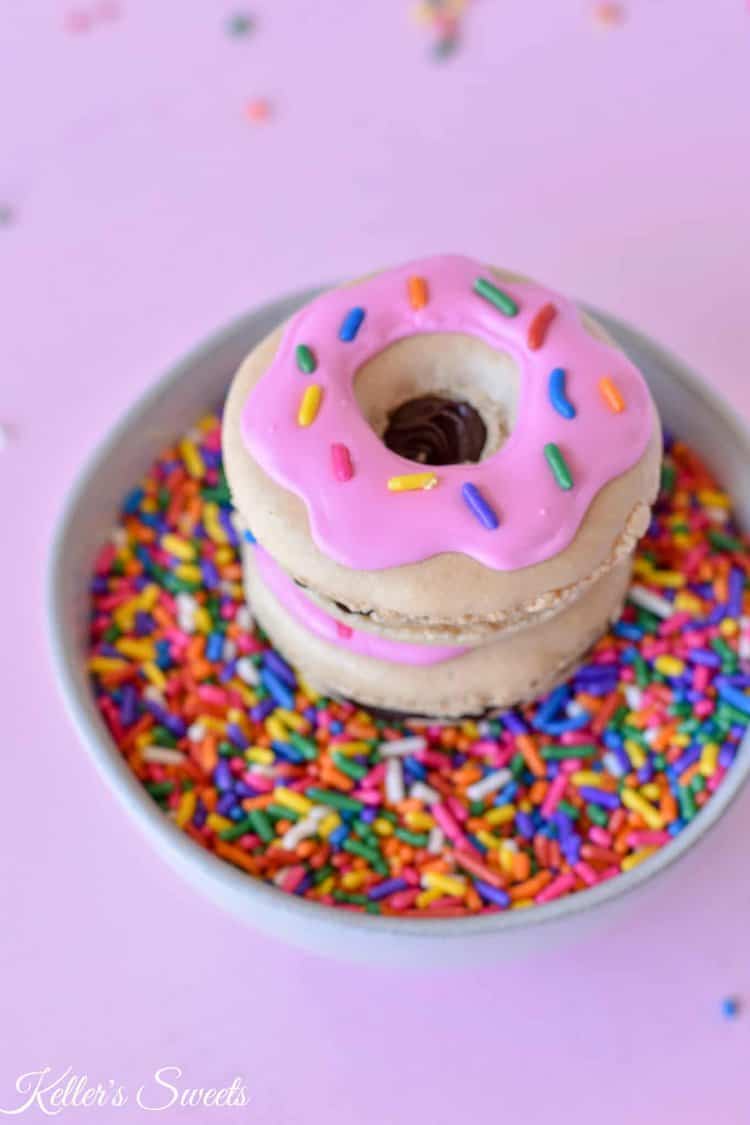 Macrons on top of bowl of sprinkles