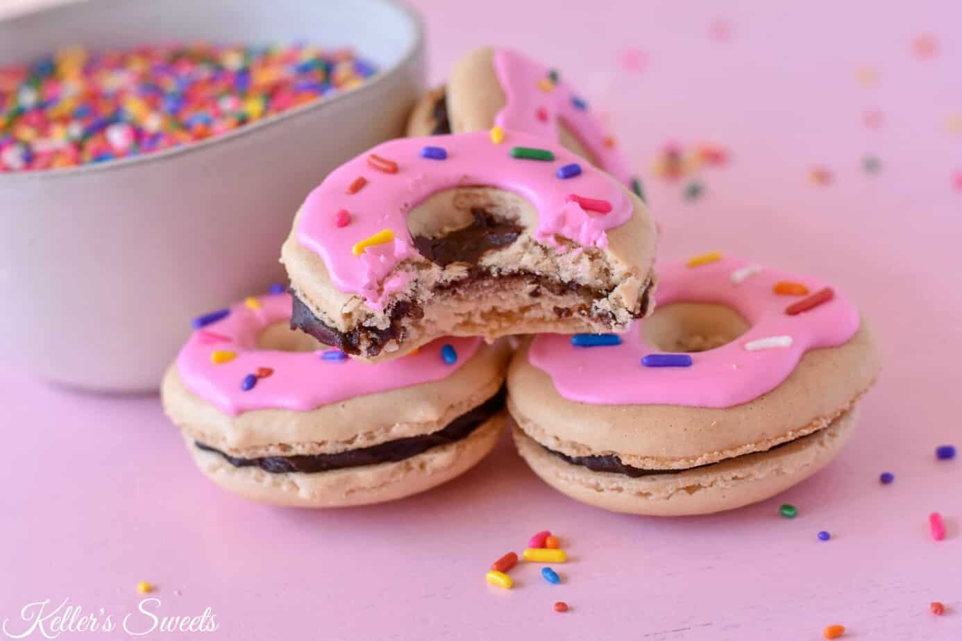 Three macrons one of which with a bite taken out of it