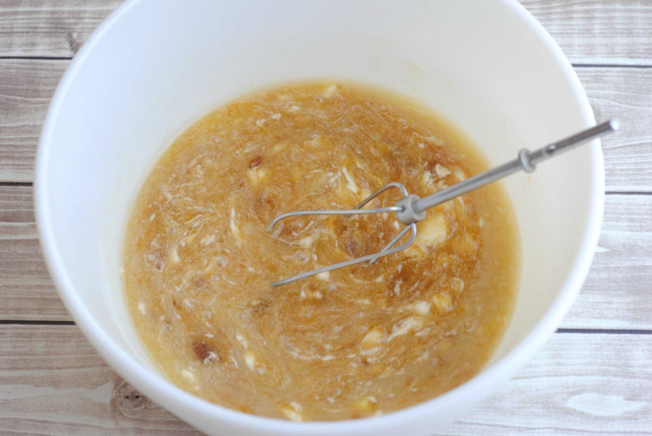 mixed up ingredients in a white bowl for mint chocolate chip cookie dough