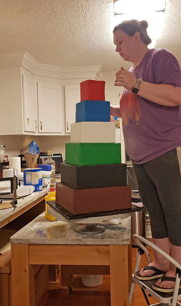 assembling six tiered sports grooms cake