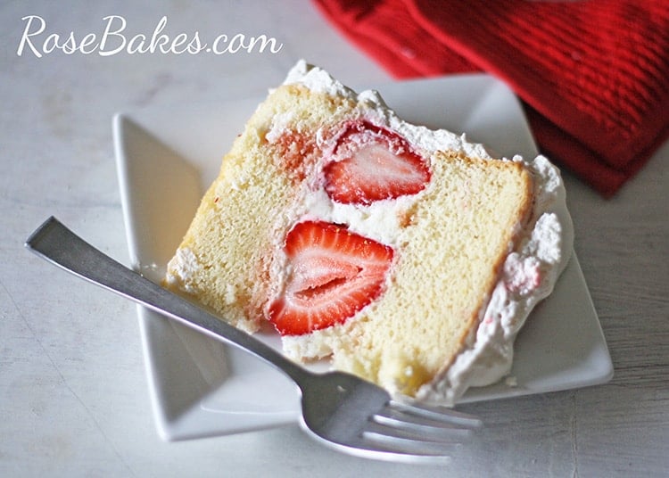 Slice of Strawberry Shortcake Cake on plate on its side