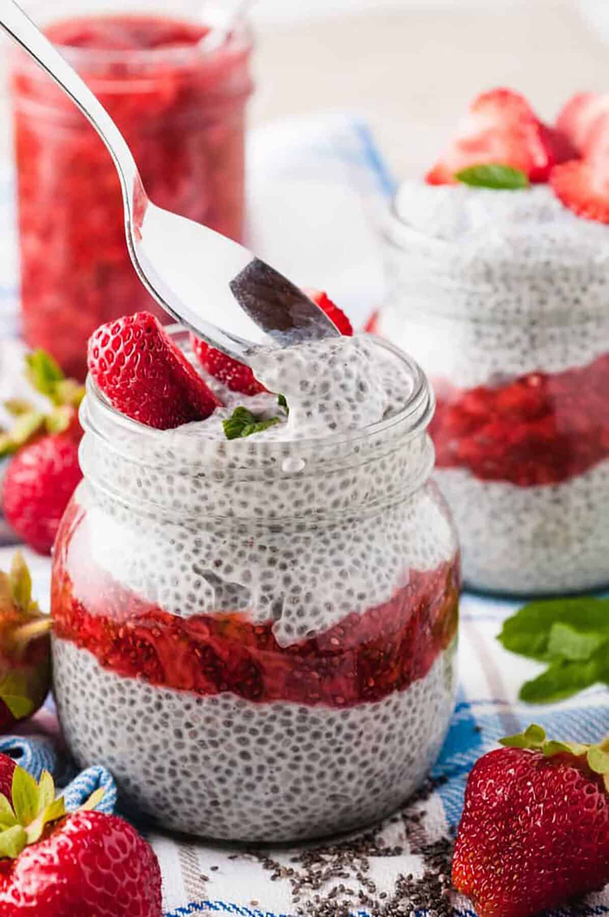 chia seed pudding layered with strawberry chia jam and fresh fruit