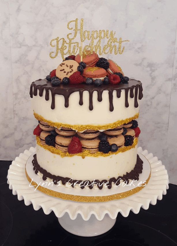 Macarons Retirement Themed Fault Line Cake with Ganache Drip and berry accents