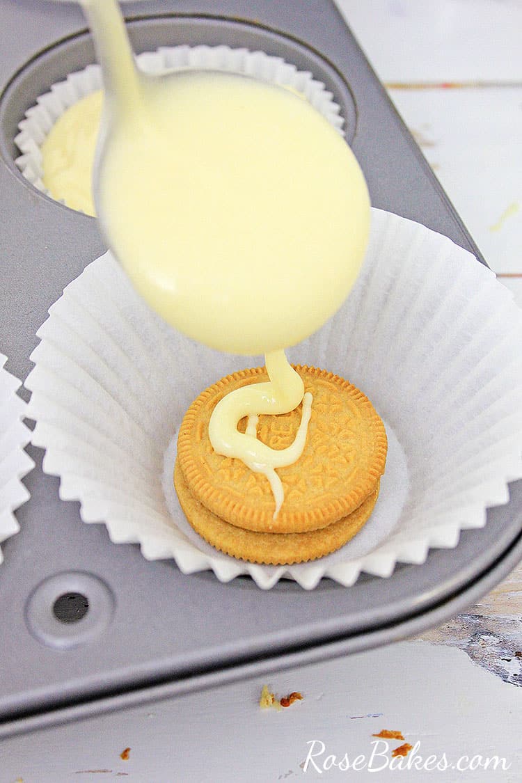 OREO Maple Creme Cookie in the bottom of a cupcake liner with batter for OREO Maple Creme Cupcakes