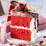 slice of red velvet cake with cream cheese frosting and ganache