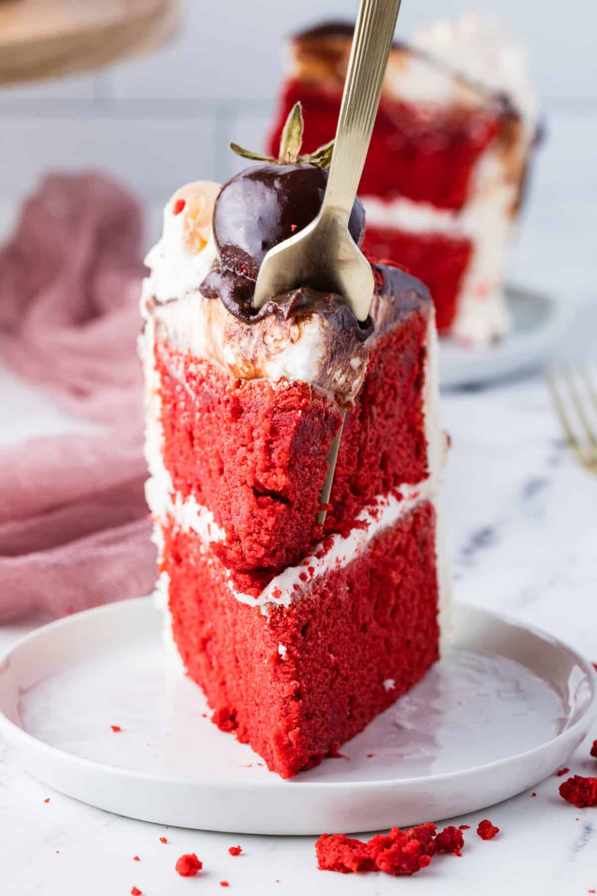 slice of red velvet cake with bite missing