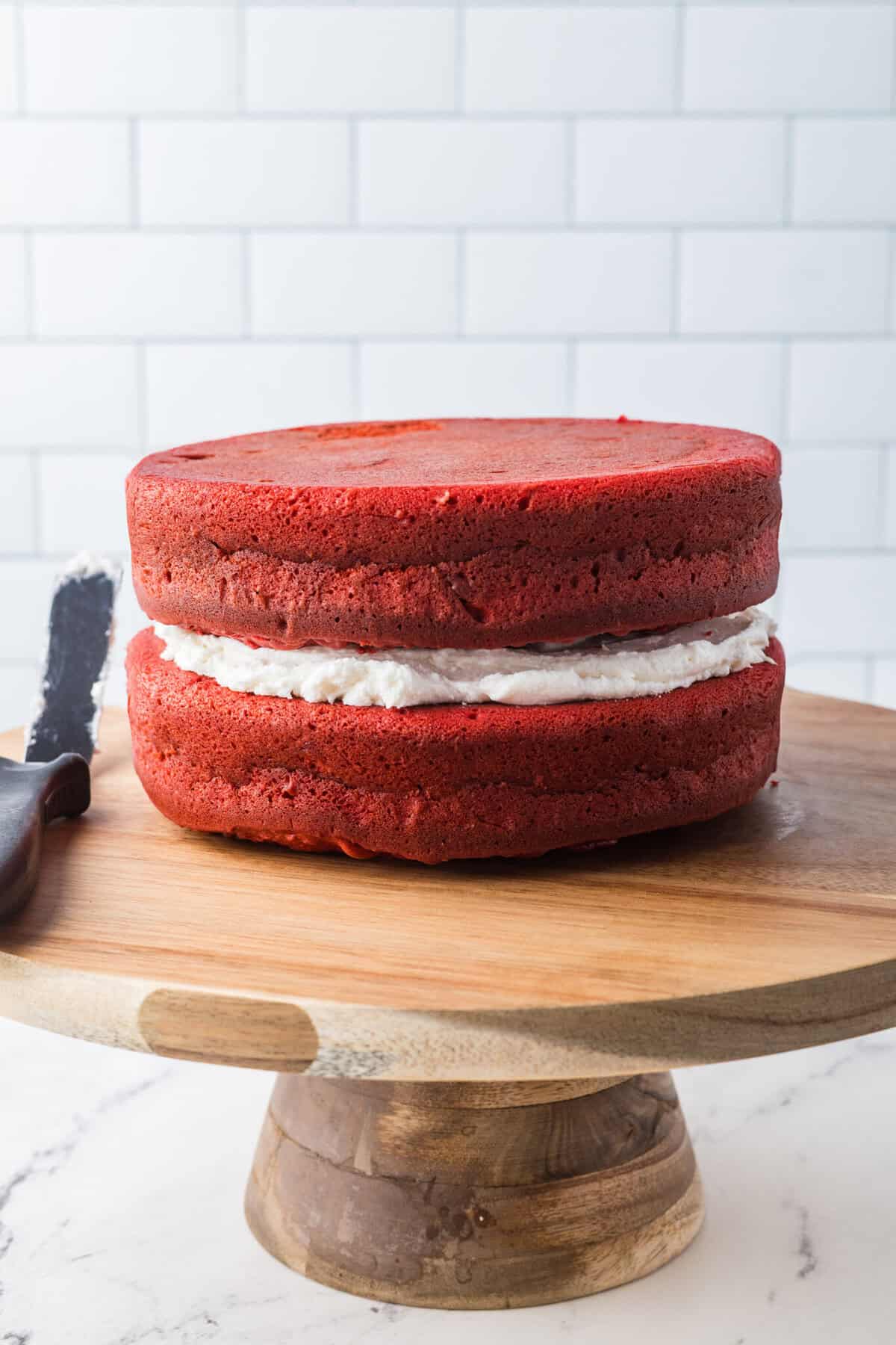 red velvet cakes with cream cheese frosting layered between