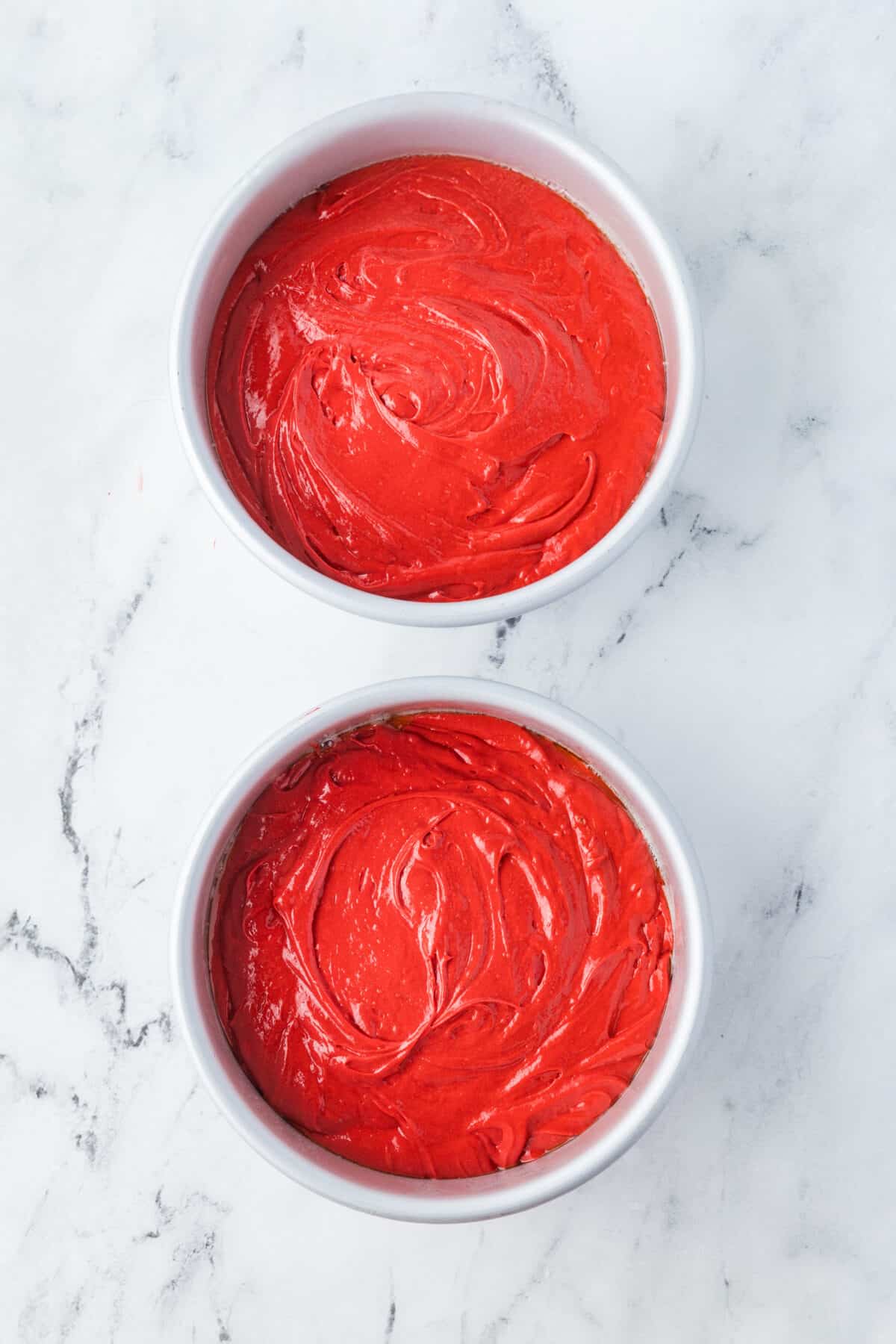 red velvet cake batter in cake pans