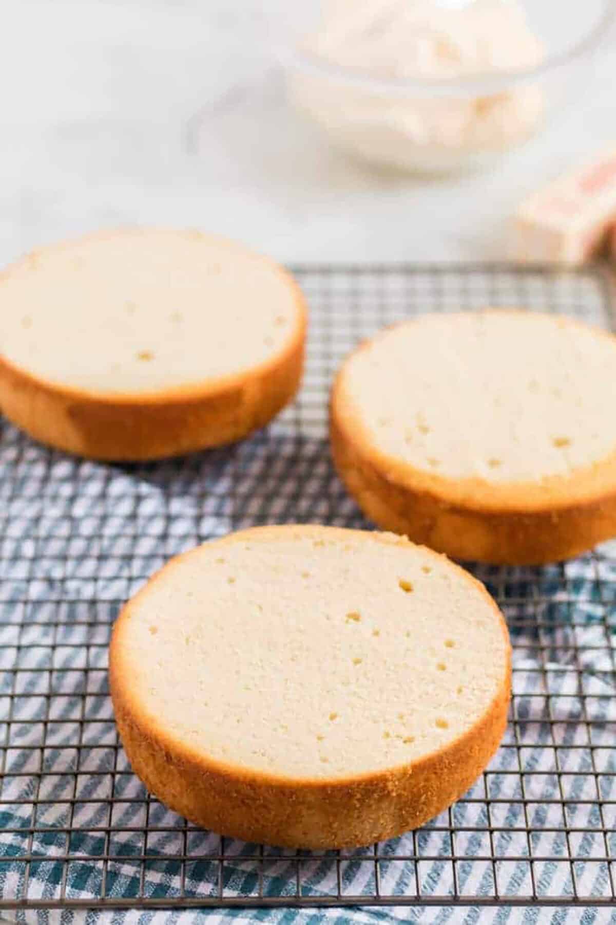 layers of vanilla cake on a cooling rack