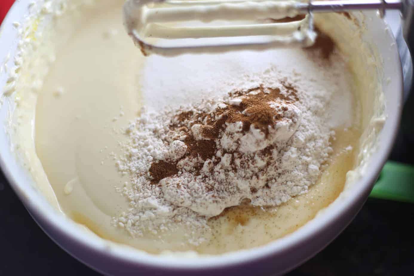 adding sugar and spices to eggnog cheesecake filling