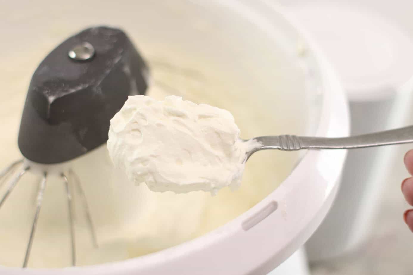 vanilla buttercream on a spoon over a mixer
