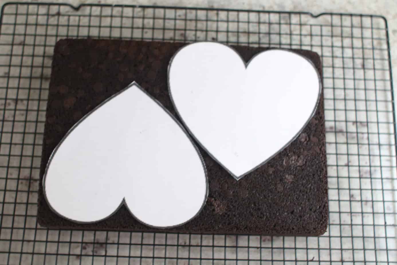 sheet cake with paper hearts laying on top