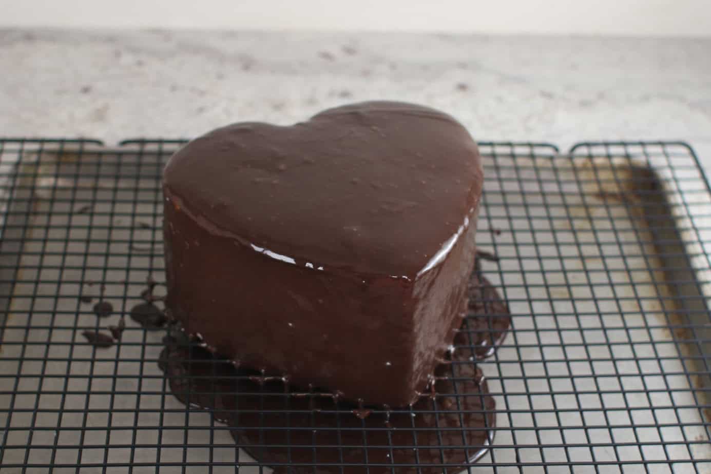 heart cake covered in poured chocolate ganache
